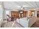 Spacious living room with custom built-in shelving, a large sectional sofa, and hardwood floors at 4411 Windsor Oaks Cir, Marietta, GA 30066