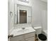 Bright bathroom featuring a white vanity, toilet, and a mirrored medicine cabinet at 622 Providence Sw Pl, Atlanta, GA 30331
