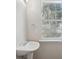 This bathroom features a pedestal sink and a window that provides natural light at 622 Providence Sw Pl, Atlanta, GA 30331