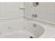 Close up view of a white soaking bathtub with jets surrounded by decorative tile at 622 Providence Sw Pl, Atlanta, GA 30331