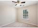 Bedroom featuring neutral carpet, ceiling fan, and windows that provide natural light at 622 Providence Sw Pl, Atlanta, GA 30331