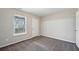 A bedroom with a large window and carpet floors at 622 Providence Sw Pl, Atlanta, GA 30331