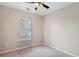 This bedroom features neutral carpet, ceiling fan, and a window providing natural light at 622 Providence Sw Pl, Atlanta, GA 30331