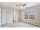 This bedroom features neutral carpet, ceiling fan, and windows with natural light at 622 Providence Sw Pl, Atlanta, GA 30331