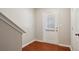 A hallway with hardwood floors and a white door at 622 Providence Sw Pl, Atlanta, GA 30331