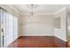 Spacious living room with hardwood floors, large windows, and sliding glass door at 622 Providence Sw Pl, Atlanta, GA 30331