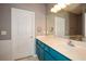 Bathroom with blue vanity, wide mirror, and contemporary lighting for a modern touch at 1130 Camry Cir, Dallas, GA 30157