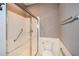 Accessible bathroom features a walk-in shower, grab bars, and neutral tile for safety and style at 1130 Camry Cir, Dallas, GA 30157