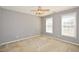 Spacious bedroom featuring neutral walls, ceiling fan, and windows providing natural light at 1130 Camry Cir, Dallas, GA 30157