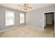 Neutral-colored bedroom with ample natural light, ceiling fan, and view into another room at 1130 Camry Cir, Dallas, GA 30157