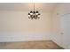Bright dining room with neutral walls, wainscoting detail, and a chandelier lighting fixture at 1130 Camry Cir, Dallas, GA 30157
