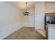 Open dining area with high ceilings, wainscoting, and stylish chandelier lighting fixture at 1130 Camry Cir, Dallas, GA 30157