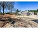Exterior view featuring common ground, mature trees, and a well-maintained property at 1130 Camry Cir, Dallas, GA 30157