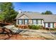 Charming single-story home featuring a brick facade, green shutters, and well-maintained landscaping at 1130 Camry Cir, Dallas, GA 30157
