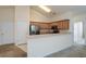 Open kitchen with light wood cabinets, stainless steel appliances, and a breakfast bar at 1130 Camry Cir, Dallas, GA 30157