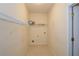 Compact laundry room with tile floor, utility connections, and wire shelving for storage at 1130 Camry Cir, Dallas, GA 30157