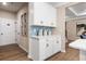 A convenient butler's pantry showcasing white cabinetry and light blue backsplash for seamless organization at 145 Silver Leaf Trce, Douglasville, GA 30134