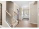 Welcoming entryway featuring wood floors, white wainscoting, a staircase with carpet, and a neutral color palette at 145 Silver Leaf Trce, Douglasville, GA 30134