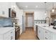 Modern kitchen with stainless steel appliances, white cabinets, quartz countertops, and wood flooring at 145 Silver Leaf Trce, Douglasville, GA 30134