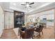 Open-concept living room boasts a fireplace, ceiling fan, and seamless flow into the modern kitchen at 145 Silver Leaf Trce, Douglasville, GA 30134