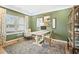 Stylish home office with green walls, light wood floors, and a large window for natural light at 145 Silver Leaf Trce, Douglasville, GA 30134