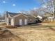 View of the home from a spacious backyard with a privacy fence at 27 Spring Se Dr, Marietta, GA 30060