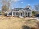 Charming single-story home featuring a welcoming front porch, landscaped yard, and classic architectural details at 27 Spring Se Dr, Marietta, GA 30060