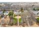 Stunning aerial perspective of a grand estate with lush landscaping and a long driveway, set in a serene, wooded location at 3977 Sweet Bottom Dr, Duluth, GA 30096