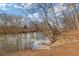 An outdoor living space offers a waterfront view, trees, and natural beauty at 3977 Sweet Bottom Dr, Duluth, GA 30096