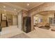 Spacious basement area with stone accents, tile floors, wine fridge, and open layout at 3977 Sweet Bottom Dr, Duluth, GA 30096