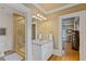 Bright bathroom featuring a glass-enclosed shower and stylish vanity with a framed mirror at 3977 Sweet Bottom Dr, Duluth, GA 30096