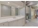 Bright bathroom features a large vanity with white cabinets, a framed mirror, and access to glass shower at 3977 Sweet Bottom Dr, Duluth, GA 30096