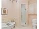 Bright bathroom featuring white fixtures, a shower, a soaking tub, and a classic design at 3977 Sweet Bottom Dr, Duluth, GA 30096