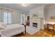 Cozy bedroom with fireplace, hardwood floors, and natural light at 3977 Sweet Bottom Dr, Duluth, GA 30096