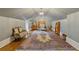 Spacious attic bedroom with sloped ceilings, hardwood floors, and an antique sitting bench at 3977 Sweet Bottom Dr, Duluth, GA 30096
