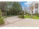 Circular driveway with lush landscaping leading to an elegant home at 3977 Sweet Bottom Dr, Duluth, GA 30096