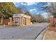 A private community entrance featuring a gatehouse, brick columns, and well-maintained surroundings at 3977 Sweet Bottom Dr, Duluth, GA 30096