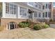 Beautiful home exterior with multiple windows, brick foundation, stairs and professional landscaping at 3977 Sweet Bottom Dr, Duluth, GA 30096