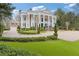 Elegant estate showcases meticulous landscaping, expansive lawn, and a circular driveway leading to the main house and a detached garage at 3977 Sweet Bottom Dr, Duluth, GA 30096