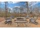 Stone fire pit with Adirondack chairs near the water offers a peaceful setting for outdoor gatherings at 3977 Sweet Bottom Dr, Duluth, GA 30096