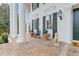 Charming porch adorned with columns, dog statues, and planters, creating an inviting entrance to this beautiful home at 3977 Sweet Bottom Dr, Duluth, GA 30096