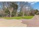 Well-maintained front yard featuring a lush lawn, mature trees, and a stone-lined driveway at 3977 Sweet Bottom Dr, Duluth, GA 30096