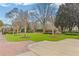 Immaculate front yard with manicured lawn, mature trees, and elegant landscaping at 3977 Sweet Bottom Dr, Duluth, GA 30096