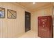 Hallway with wooden panels, a safe, and beige tile floors at 3977 Sweet Bottom Dr, Duluth, GA 30096