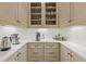 Well-organized butler's pantry with marble countertops, custom cabinets, and under-cabinet lighting at 3977 Sweet Bottom Dr, Duluth, GA 30096