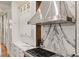 Close-up of a modern kitchen featuring stainless steel appliances, marble countertops, and a gas range at 3977 Sweet Bottom Dr, Duluth, GA 30096