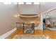 Elegant landing with a decorative wrought iron railing, hardwood floors, and open playroom space at 3977 Sweet Bottom Dr, Duluth, GA 30096