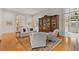 Bright living room featuring hardwood floors and a large display cabinet at 3977 Sweet Bottom Dr, Duluth, GA 30096