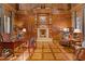 Spacious office with wood paneled walls, fireplace, hardwood flooring, and custom built-ins at 3977 Sweet Bottom Dr, Duluth, GA 30096