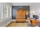 Traditional home office with a wooden desk, elegant armoire, and shuttered windows providing natural light at 3977 Sweet Bottom Dr, Duluth, GA 30096